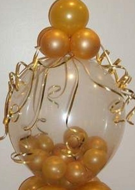 Bobo balloon with a cluster on top and bottom of gold balloons arranged in box