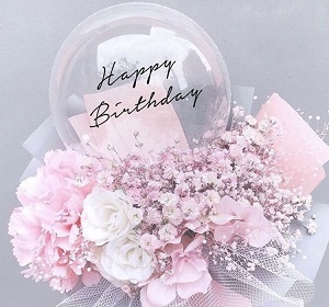 Clear transparent balloons with birthday print and pastel flowers bouquet with net