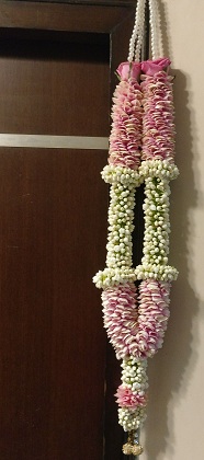 Wedding ceremony ritual traditional jaimala with fresh flowers white rajnigandha and pink roses for bride and groom