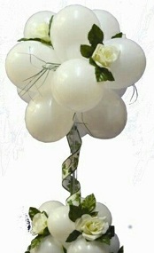 10 white balloons on sticks with 4 white balloons at bottom with for decoration on stick arranged in a box with ribbons and white flowers