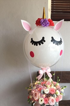 bubble transparent balloon with eyes and hat pink balloons inside with pink flowers