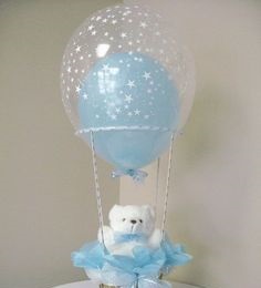 Transparent hot balloon filled with a single Blue balloon and tied to a basket with White Teddy and Blue wrapping