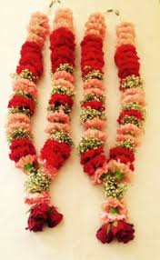 Wedding ceremony ritual traditional jaimala with fresh Carnations roses babies breath for bride and groom