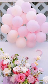 Basket of pink white mix 20 flowers with 10  pastel balloons cluster on top with leaves