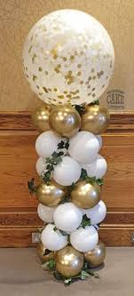 20 white gold balloons at bottom with white flowers leaves 1 bobo balloon on top of stick