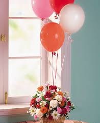 Four balloons air filled with sticks attached to flowers basket
