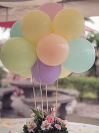 Basket of  mix 20 flowers with 10 balloons cluster on top with leaves