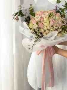 20 White and baby pink Roses Bouquet in white net wrapping and pink ribbons