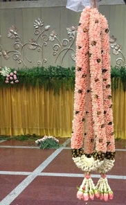 Wedding ceremony ritual traditional jaimala with fresh flowers white rajnigandha and pink roses for bride and groom