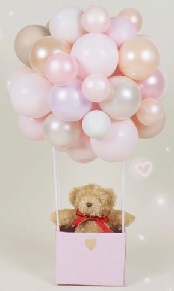 315 Air filled cluster of pink balloons with a 6 inches teddy in a box with flowers