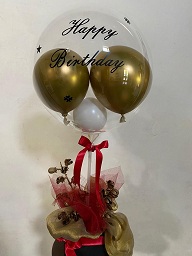 1 clear air filled balloon and gold balloon indside with dried flowers gold and red net in box
