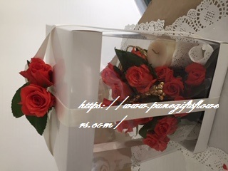 Luxury Transparent gift box with orange roses and a candle