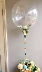 Clear Balloon attached to assorted flowers basket
