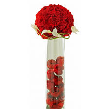 12 roses round arrangement on top of vase with petals inside vase.