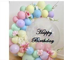 Bubble happy birthday balloon resting on 30 pastel balloons decorated with leaves and flowers arch style