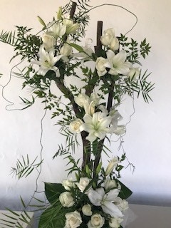 White Lilies and white roses arranged on a 3 feet organic wood