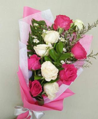 10 White Light Pink Roses Bouquet in pink and white paper and net wrapping