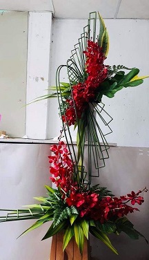 Folded Umbrella grass sticks with Red Flowers at base and top on a 2 tier