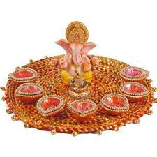 Ganesh ji with 8 diyas in decorated thali