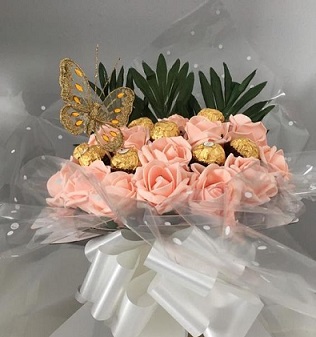 16 Ferreo rocher Chocolates with a 10 pasted pink roses in the same Bouquet and butterfly wrapped in clear net