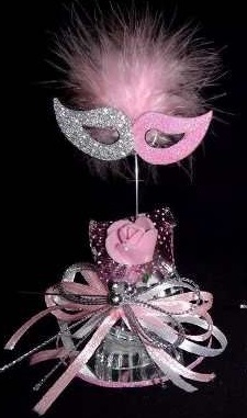 Masquerade floral arrangement with masque pink rose feathers and pink ribbons