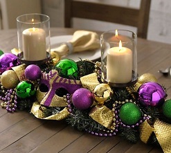 Masquerade party arrangement with 2 candles decorated with colour balls and beads