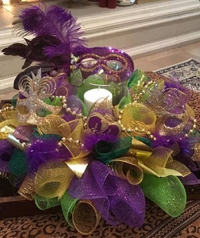 Masquerade party arrangement with candle decorated with colour balls masks and beads
