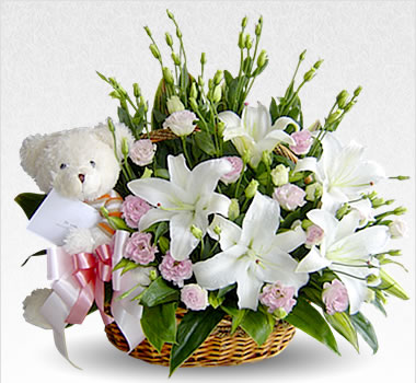 Lilies and teddy in a basket