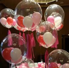 Small white red and pink balloons stuffed in 5 transparent balloons for party decoration