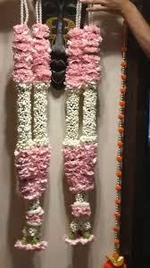 Wedding ceremony ritual traditional jaimala with fresh flowers white rajnigandha and pink roses for bride and groom