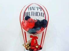 Happy Birthday Printed on Transparent Balloon stuffed with 3 black and 3 balloons Tied with ribbons to a basket containing 16 Ferrero rocher chocolates