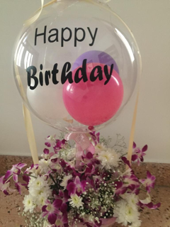 1 Clear transparent bubble bobo balloon with letter happy birthday Sticker stuffed with balloons and tied with ribbon to a basket of orchids and white flowers