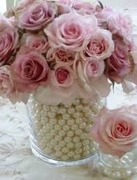 Pink roses in a glass jar with white pearls