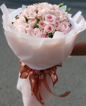 100 Soft millennial Pink Roses Bouquet in white net wrapping