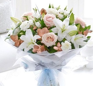 4 White Lilies with 20 peach pink roses in a bouquet wrap in white