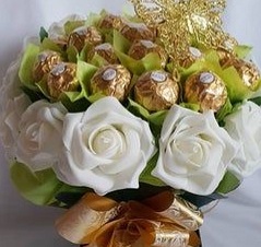 15 white flowers and 16 ferroro chocolates arranged in centre