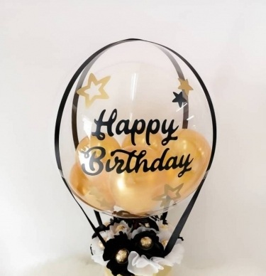 Bobo bubble transparent balloon with happy birthday print and yellow gold balloons inside with 8 white roses 5 ferrero