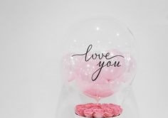 1 Printed Love You transparent Balloon with 3 pink balloons and pink petals inside and tied to 15 pink roses basket